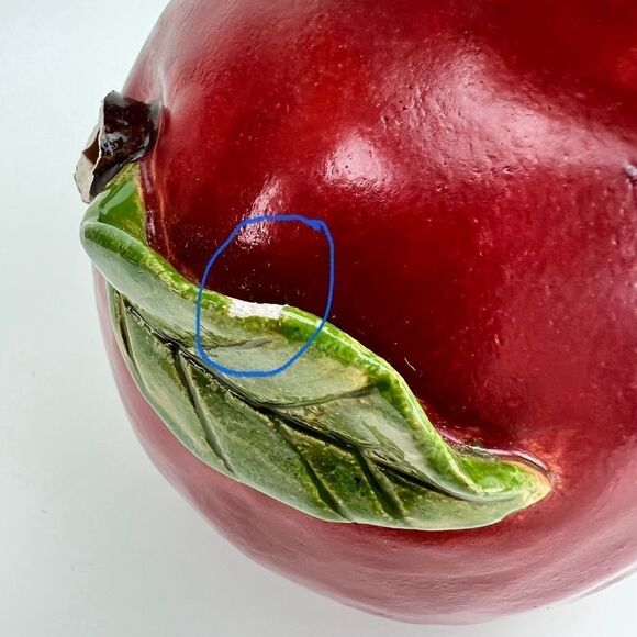 CARRIANNE L HENDRICKSON woman with beak hat sitting on apple sculpture 2… - Picture 13 of 16